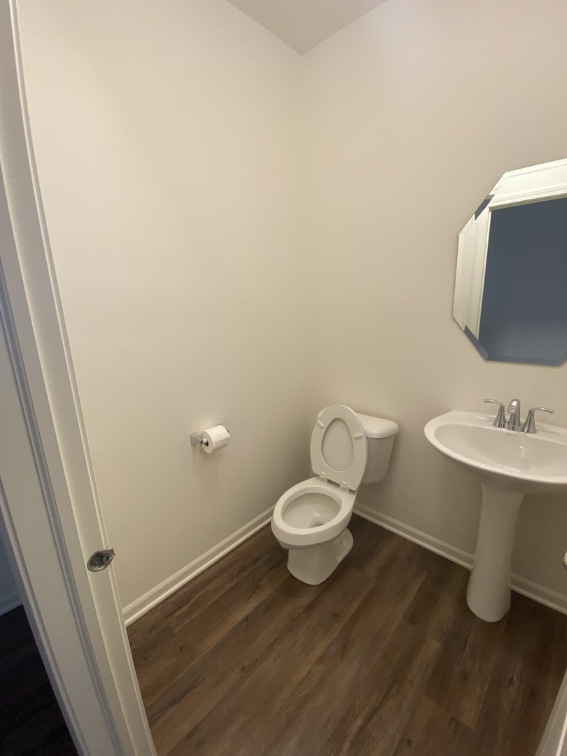1009 North Draper Road McHenry, IL 60050 - Photo 8 of 20 a bathroom with a sink and a toilet