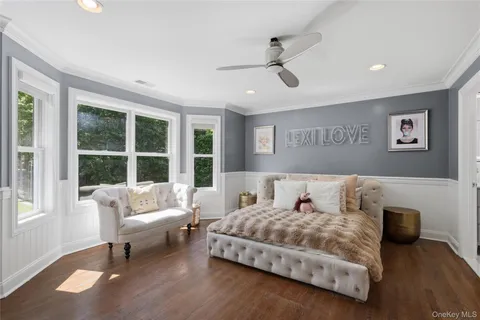 a bedroom with bed window and a ceiling fan