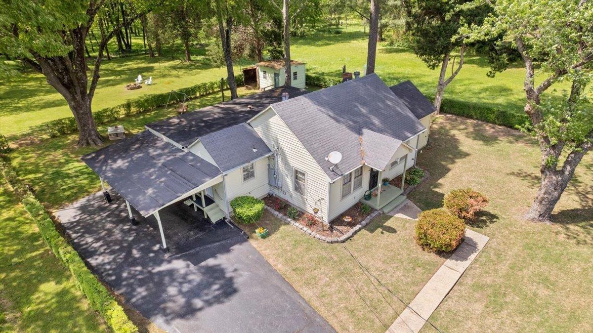 an aerial view of a house with yard swimming pool and outdoor seating