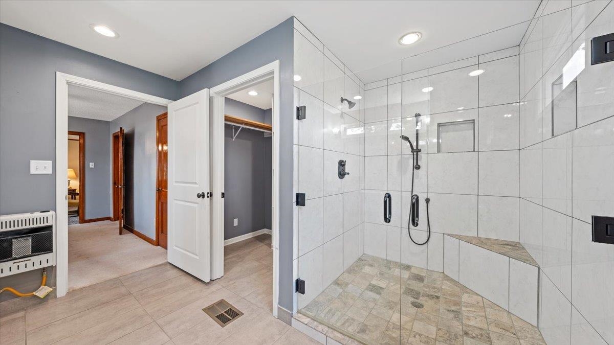1601 Wynne Road Cordova, TN 38016 - Photo 7 of 31 a bathroom with a glass shower door a sink and a shower