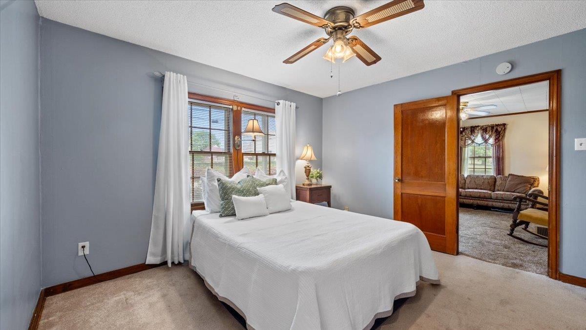 1601 Wynne Road Cordova, TN 38016 - Photo 10 of 31 a bedroom with a large bed and a chandelier