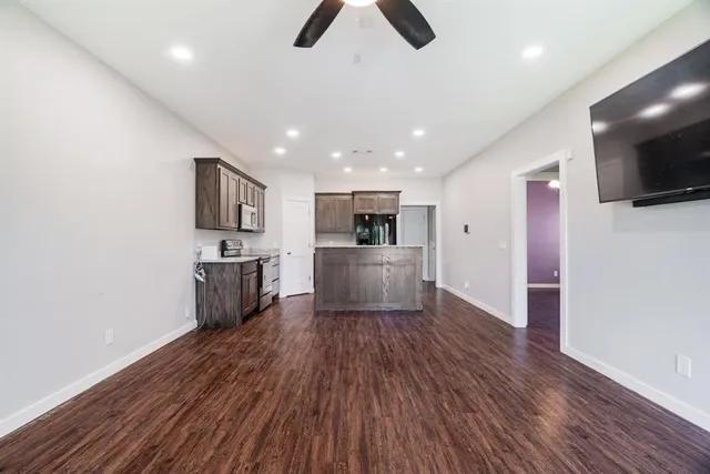 a view of kitchen with sink microwave and refrigerator