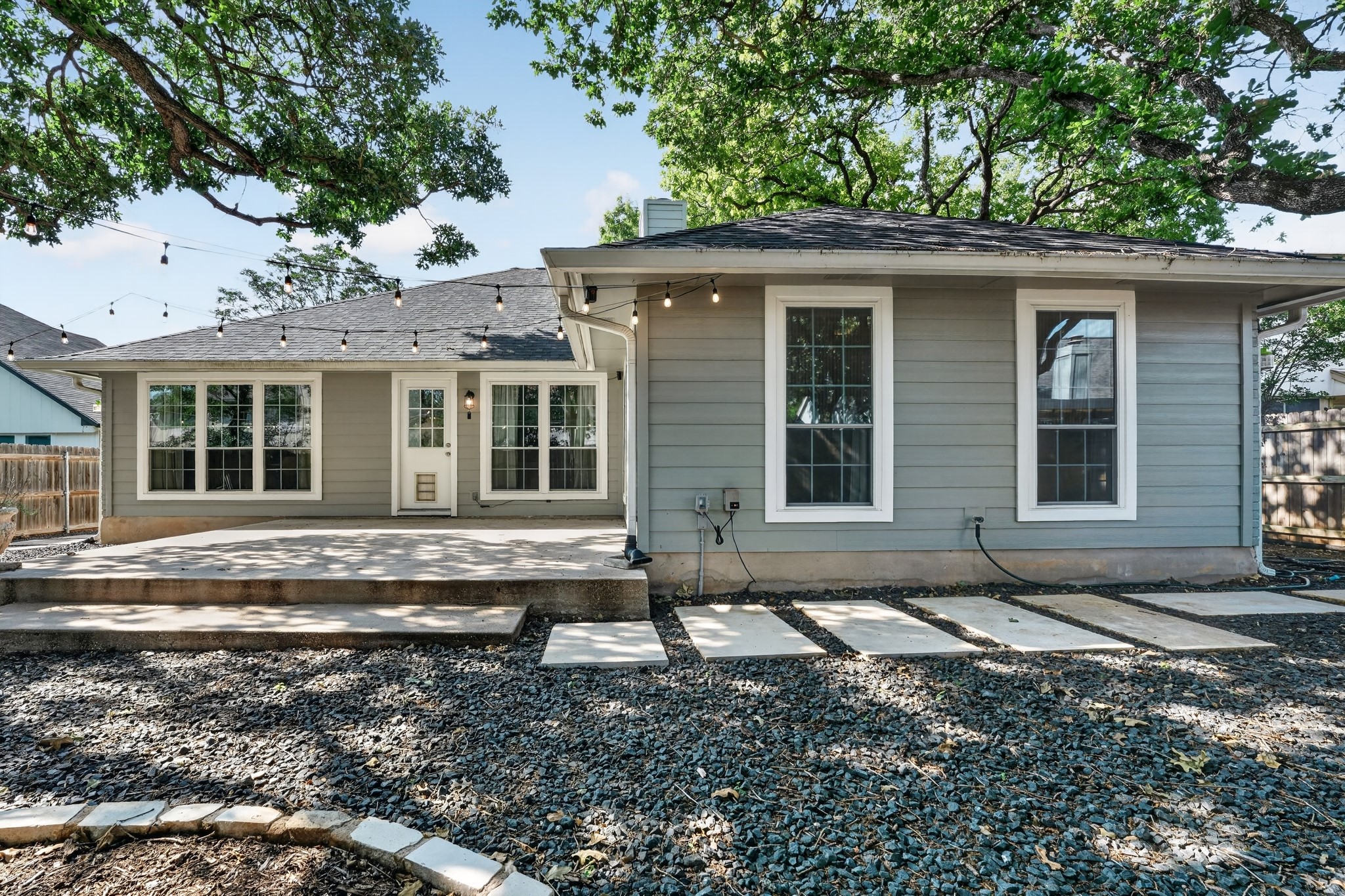 1811 Old Mill Road Cedar Park, TX 78613 - Photo 35 of 39 A spacious backyard patio provides ample space for outdoor entertaining, surrounded by mature shade trees.