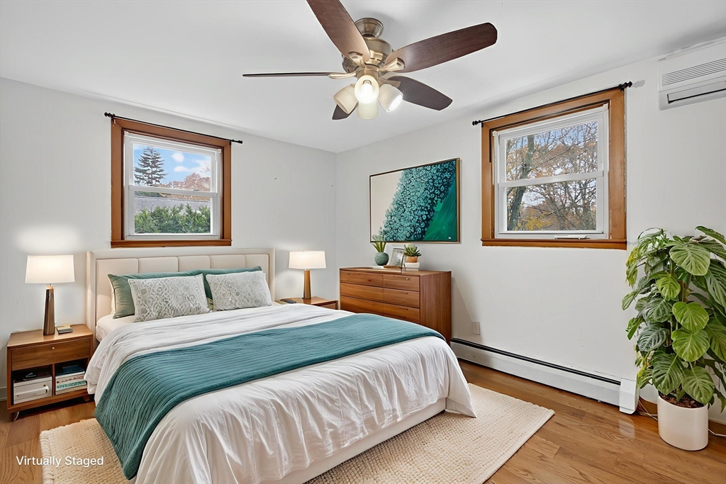 33 Isleboro Street Worcester, MA 01606 - Photo 14 of 36 a bedroom with a large bed and a potted plant