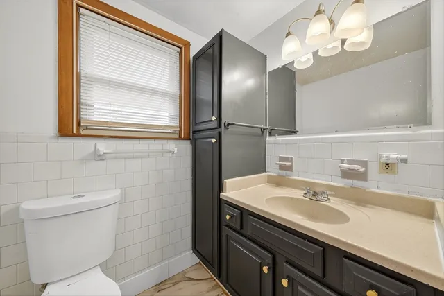 a bathroom with a sink a toilet and a mirror