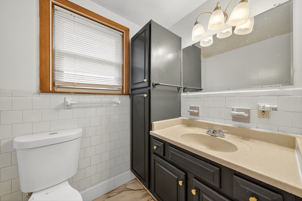 33 Isleboro Street Worcester, MA 01606 - Photo 17 of 36 a bathroom with a sink a toilet and a mirror