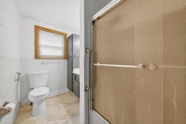 a white toilet sitting next to a bathroom sink