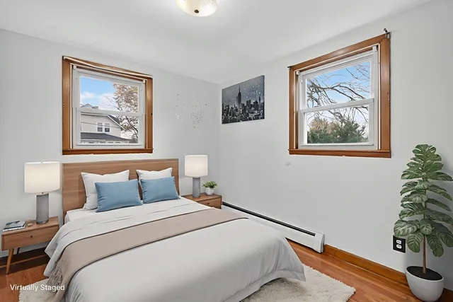 a bedroom with bed and paintings on the wall