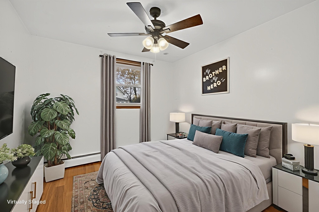 33 Isleboro Street Worcester, MA 01606 - Photo 21 of 36 a bedroom with a bed and a chandelier