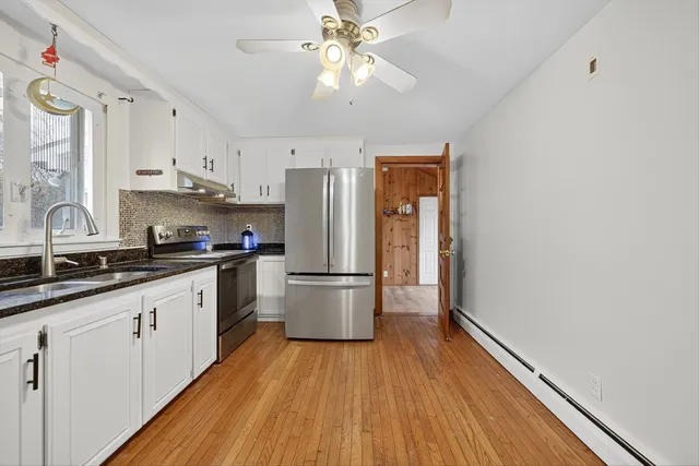 a kitchen with a refrigerator and a sink