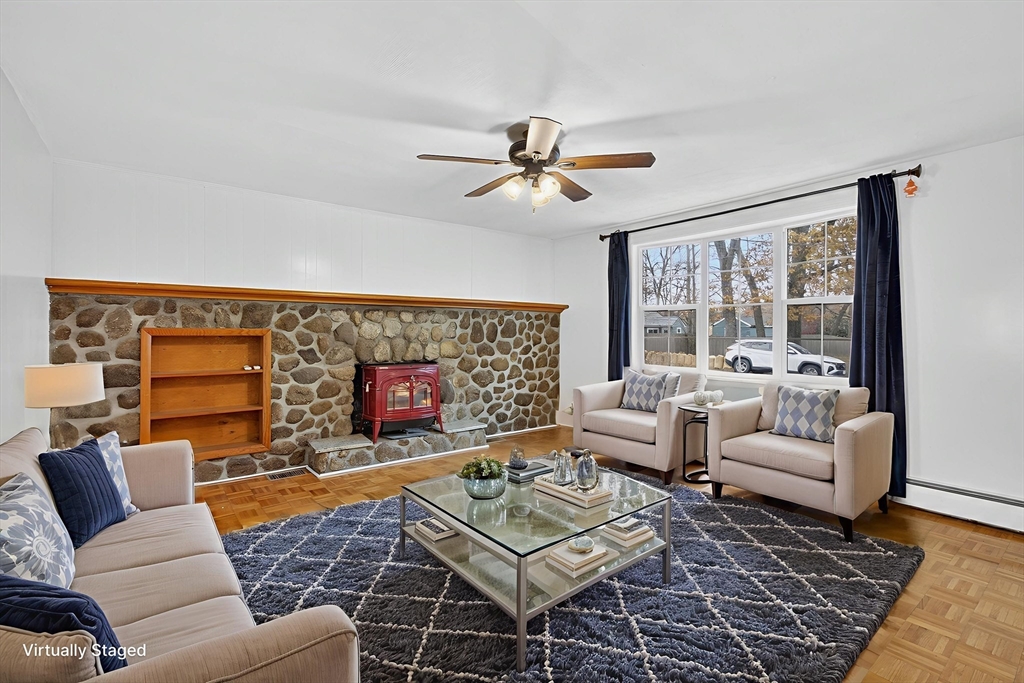 33 Isleboro Street Worcester, MA 01606 - Photo 8 of 36 a living room with furniture a flat screen tv and a floor to ceiling window