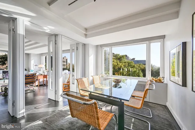 a living room with furniture and floor to ceiling windows