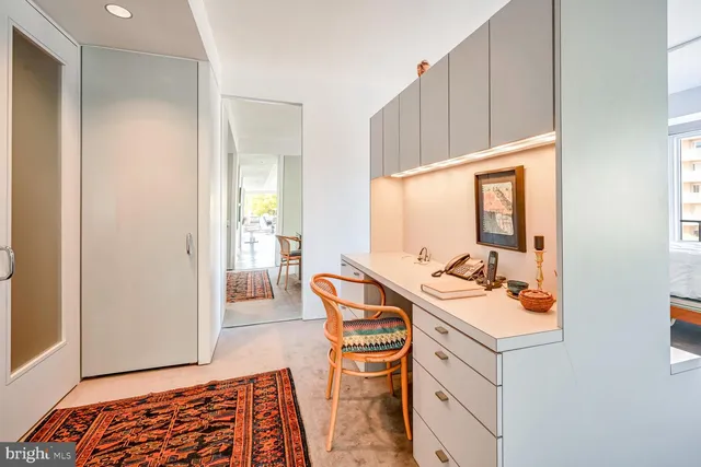 a spacious bedroom with a bed and a large window