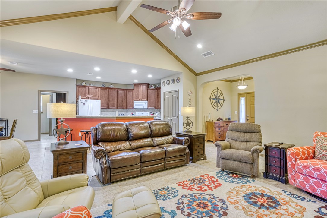 9945 Oxford Cemetery Road Madisonville, TX 77864 - Photo 10 of 42 Living area featuring ceiling fan, high vaulted ceiling, beam ceiling, recessed lighting, and crown molding