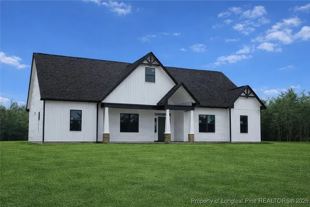 a front view of house with yard and green space