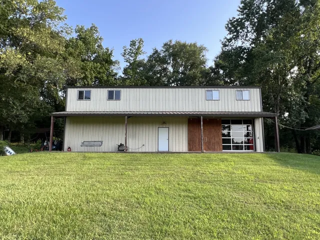 a view of a house with a yard and a garage
