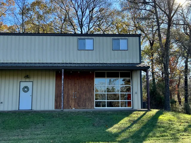 a view of a backyard with large trees