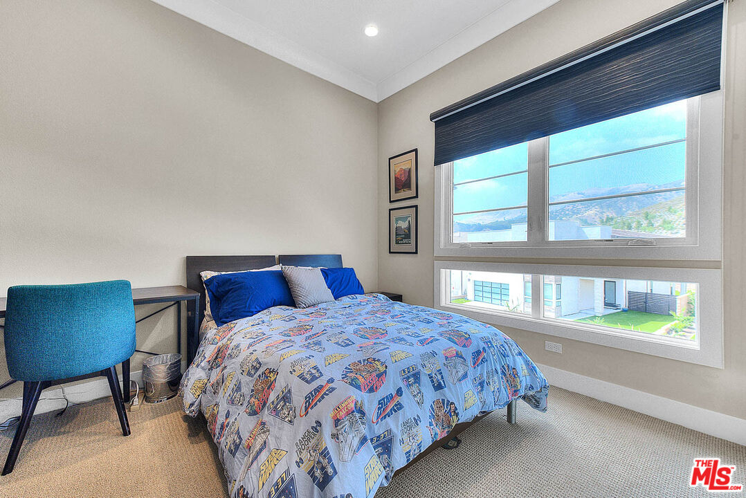 20558 Overlook Court Porter Ranch, CA 91326 - Photo 35 of 48 a bedroom with a bed and a chair