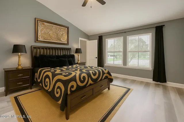 a bed sitting in a bedroom next to a window