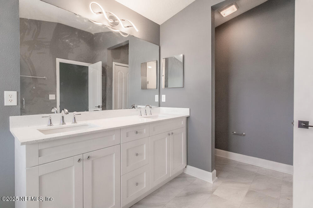 1751 Hollow Glen Drive Middleburg, FL 32068 - Photo 13 of 23 a bathroom with a double vanity sink and a mirror