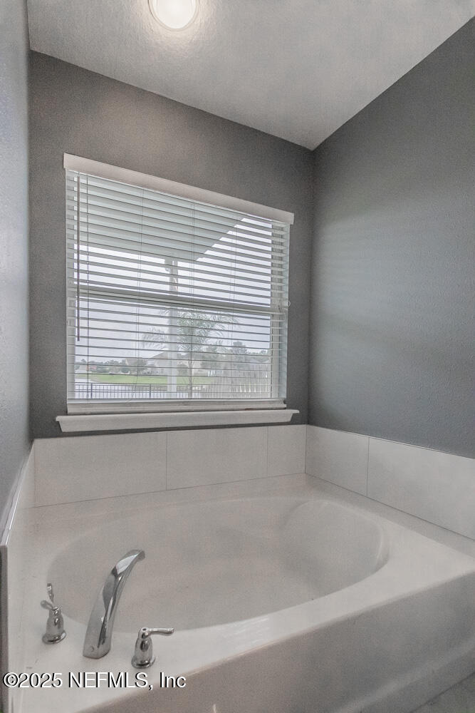 1751 Hollow Glen Drive Middleburg, FL 32068 - Photo 15 of 23 a bath tub sitting in a bathroom next to a window