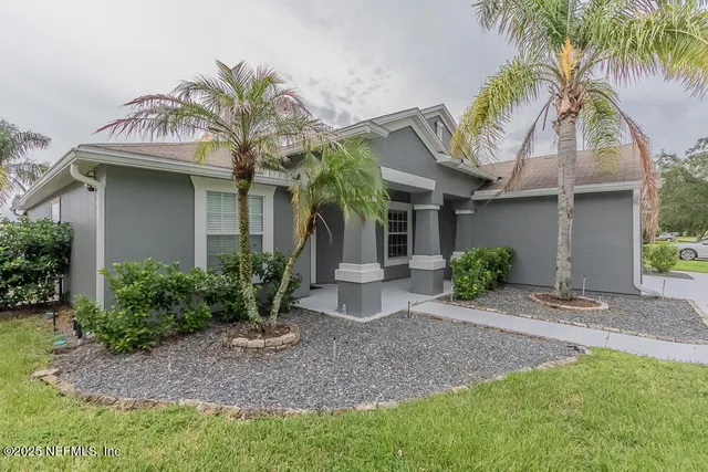 a view of a house with fountain and a palm tree