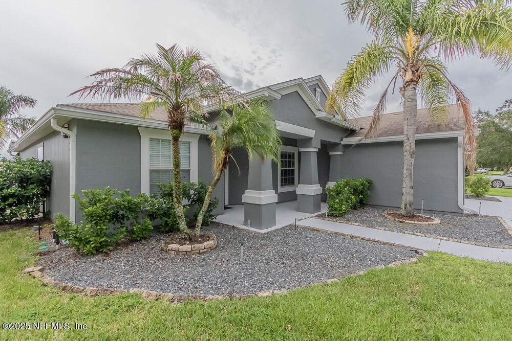 1751 Hollow Glen Drive Middleburg, FL 32068 - Photo 2 of 23 a view of a house with fountain and a palm tree