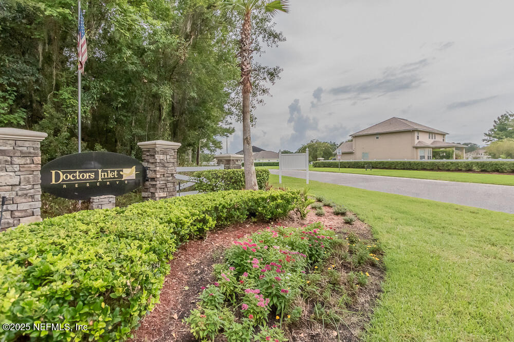 1751 Hollow Glen Drive Middleburg, FL 32068 - Photo 23 of 23 a garden with a bench in front of the house