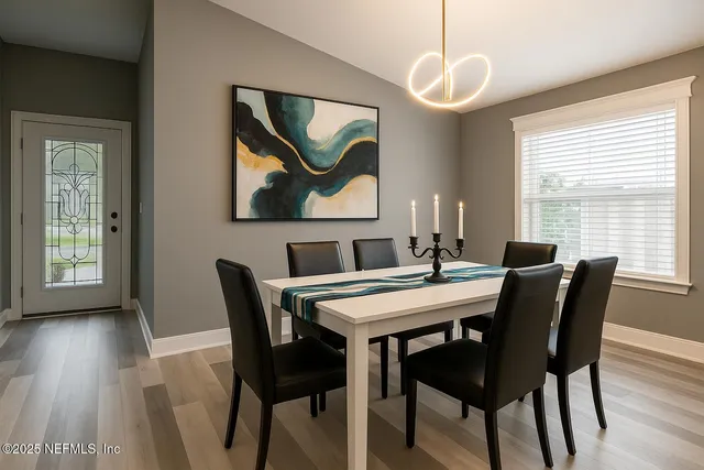 a view of a dining room with furniture window and wooden floor
