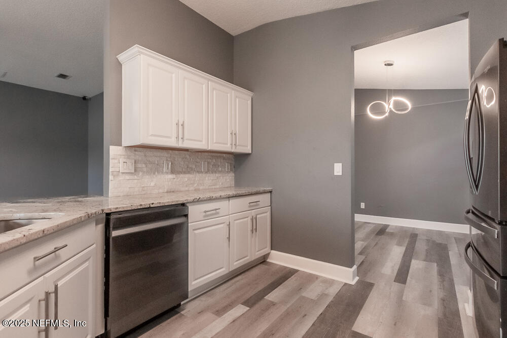 1751 Hollow Glen Drive Middleburg, FL 32068 - Photo 5 of 23 a kitchen with a sink appliances and cabinets