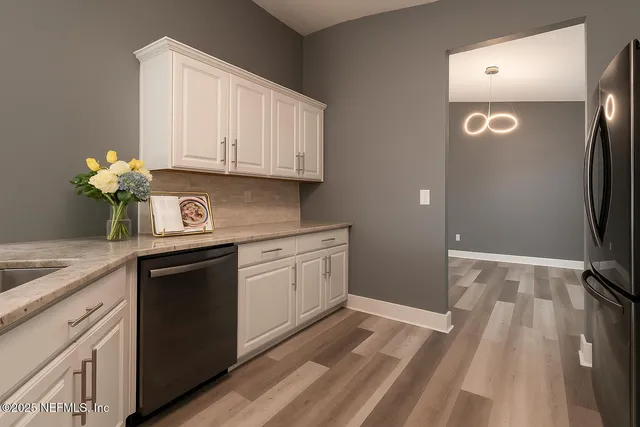 a kitchen with granite countertop cabinets stainless steel appliances and a counter space