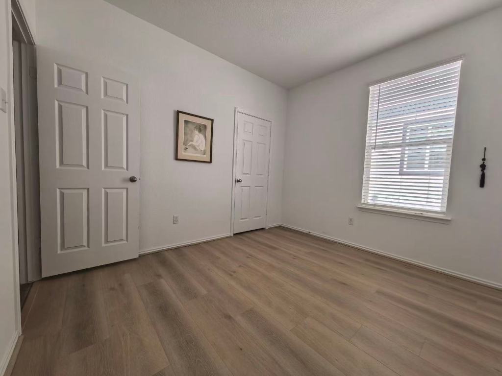 1521 Hope Rnch Road Leander, TX 78641 - Photo 11 of 15 Unfurnished bedroom with baseboards and light wood-style flooring