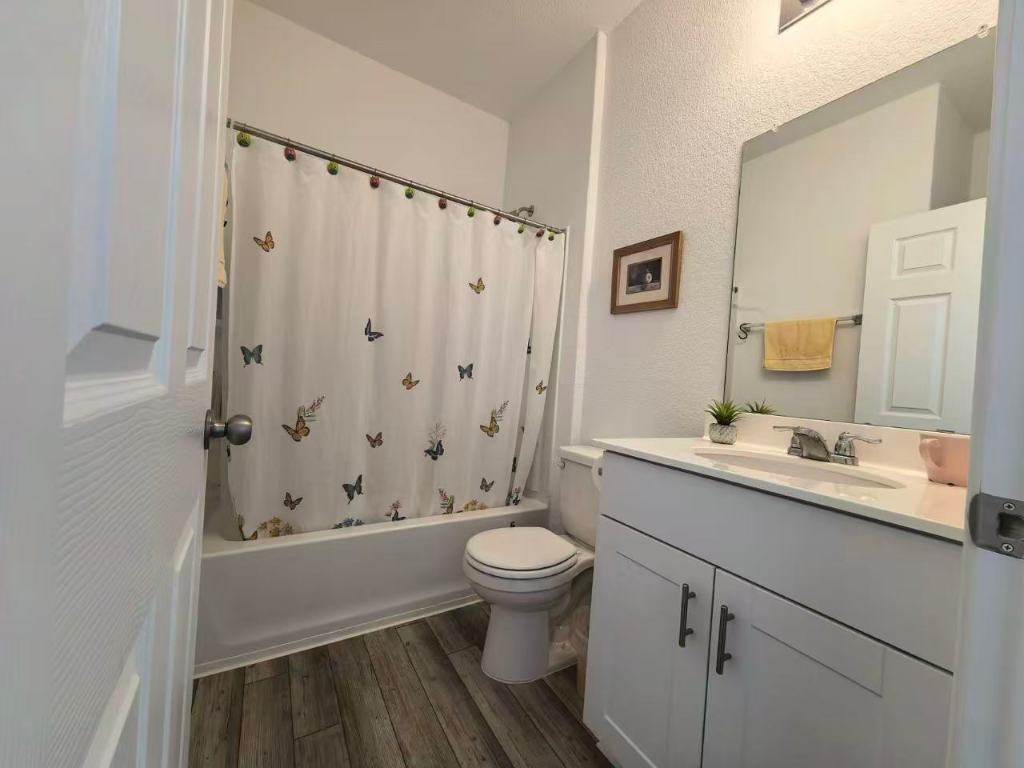 1521 Hope Rnch Road Leander, TX 78641 - Photo 14 of 15 Full bathroom with a textured wall, vanity, shower / bath combination with curtain, and dark wood finished floors