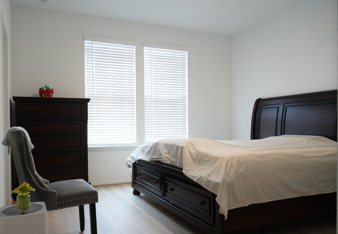 1521 Hope Rnch Road Leander, TX 78641 - Photo 9 of 15 Bedroom featuring wood finished floors and baseboards