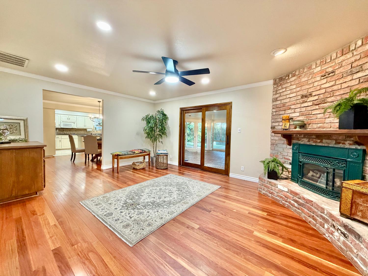 5706 Jeff Way Carmichael, CA 95608 - Photo 7 of 48 Great room with brick purple and gas fireplace insert with blower. New canned lights and ceiling fan/light with remote control.