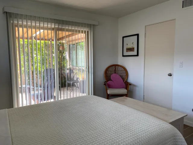 a bedroom with a bed and a large window