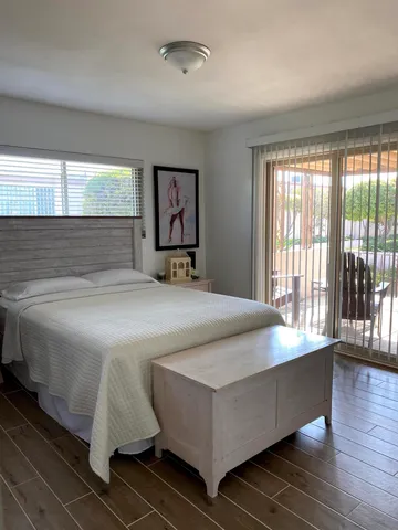 a bedroom with a large bed and a large window