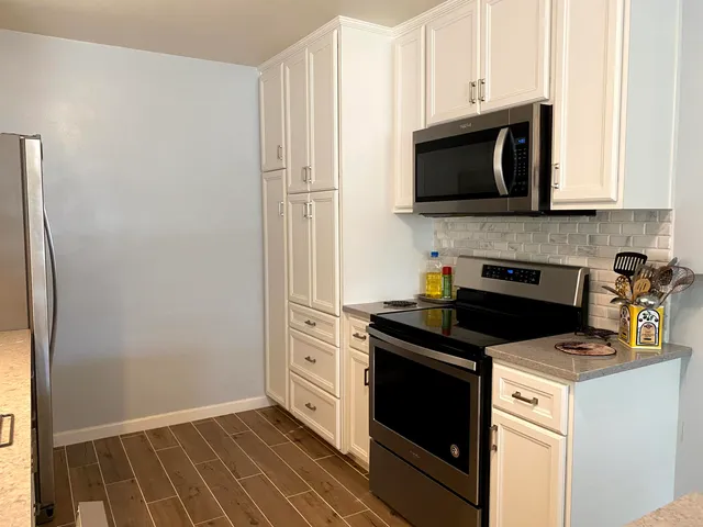 a kitchen with a stove and a microwave