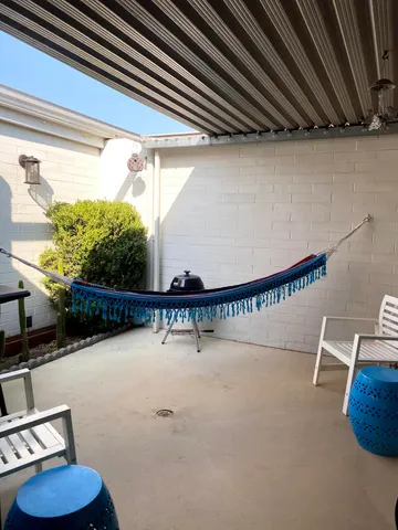a view of swimming pool with outdoor seating and a potted plant