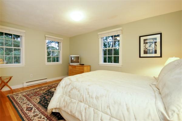 11 Tricorne Road Lexington, MA 02421 - Photo 11 of 15 a bedroom with a bed and wooden floor
