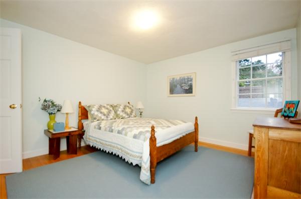 11 Tricorne Road Lexington, MA 02421 - Photo 12 of 15 a bed sitting in a room with a table and a potted plant