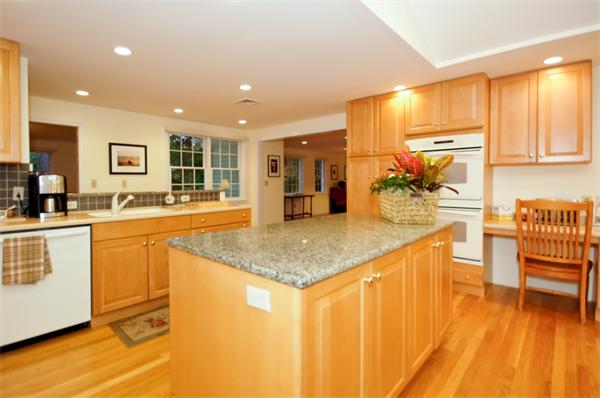 11 Tricorne Road Lexington, MA 02421 - Photo 3 of 15 a kitchen with stainless steel appliances granite countertop a sink and cabinets