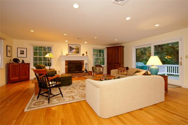 11 Tricorne Road Lexington, MA 02421 - Photo 8 of 15 a living room with fireplace furniture and a wooden floor