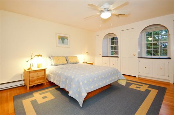 11 Tricorne Road Lexington, MA 02421 - Photo 10 of 15 a bedroom with a bed and a chandelier