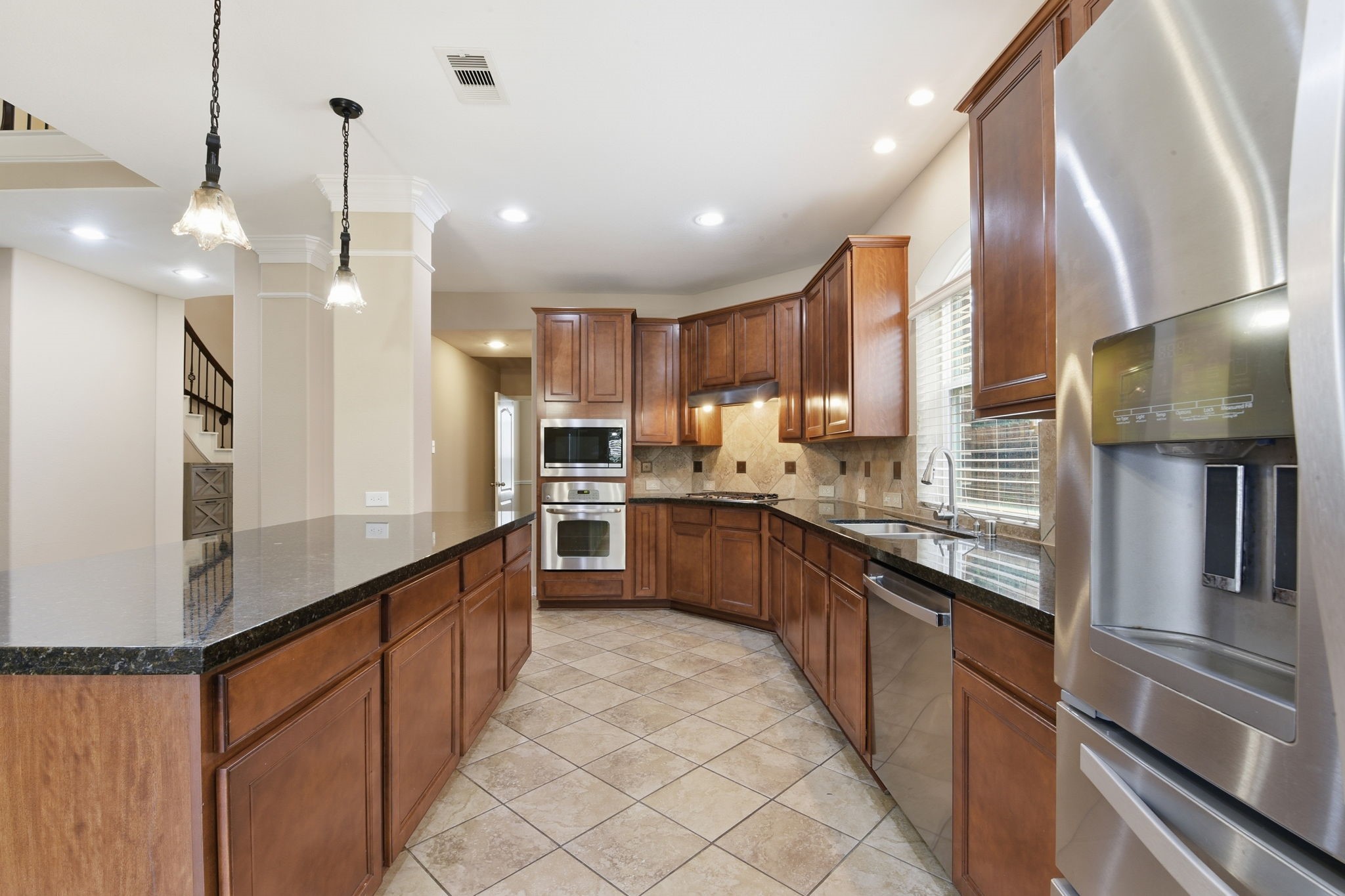 29019 Comal Karst Drive Spring, TX 77386 - Photo 13 of 50 a large kitchen with granite countertop lots of counter space and stainless steel appliances