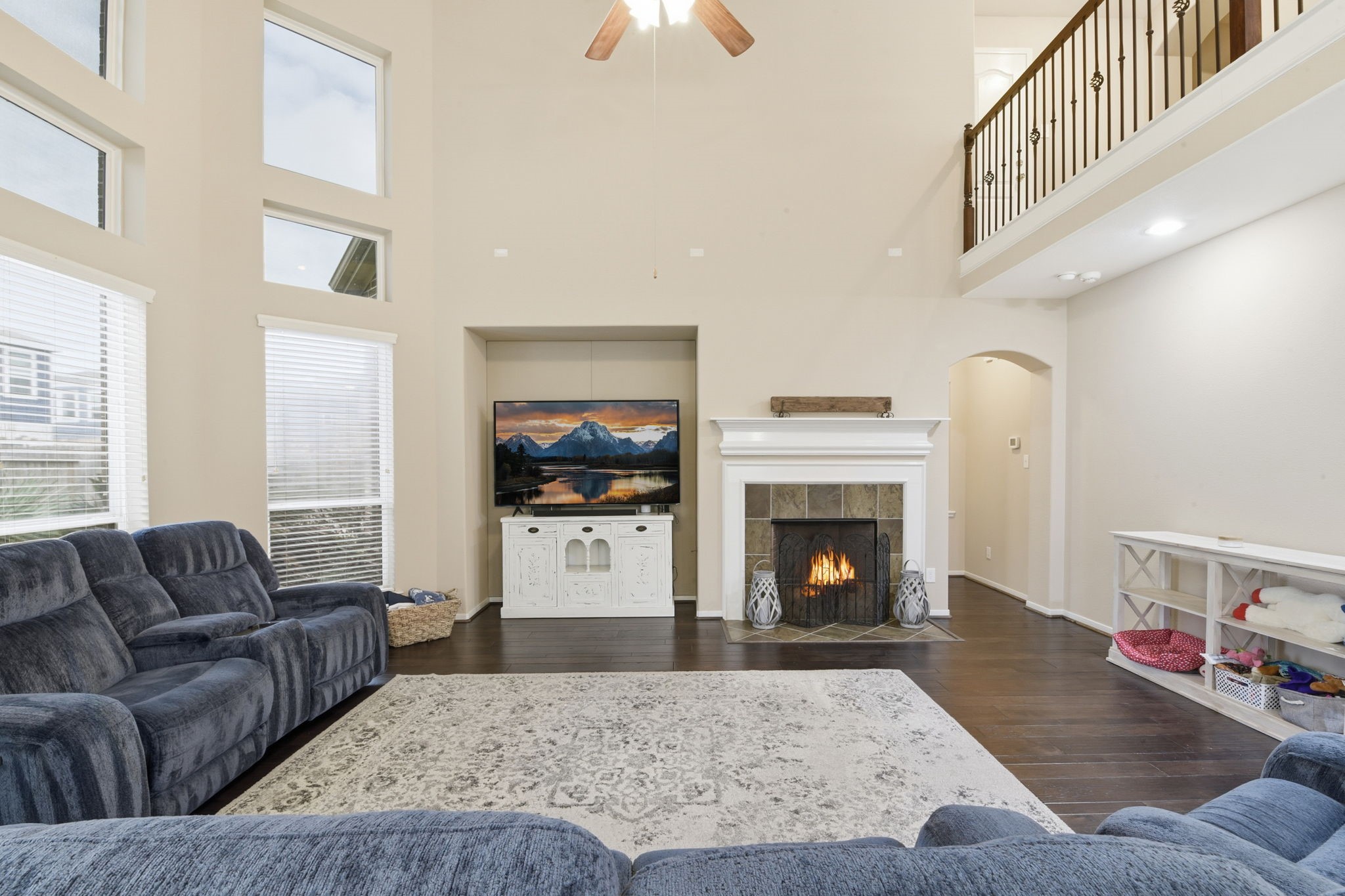 29019 Comal Karst Drive Spring, TX 77386 - Photo 20 of 50 a living room with furniture a fireplace and a flat screen tv