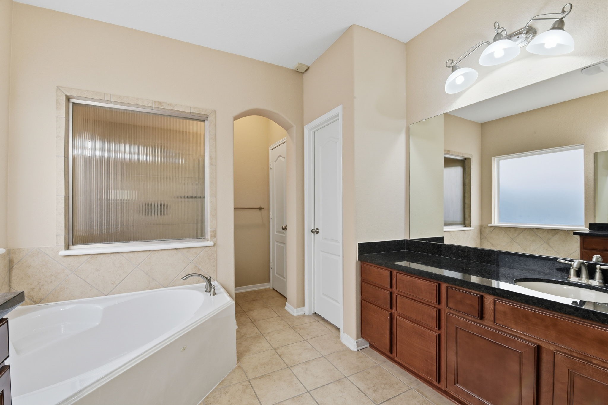 29019 Comal Karst Drive Spring, TX 77386 - Photo 27 of 50 a spacious bathroom with a granite countertop tub sink and mirror