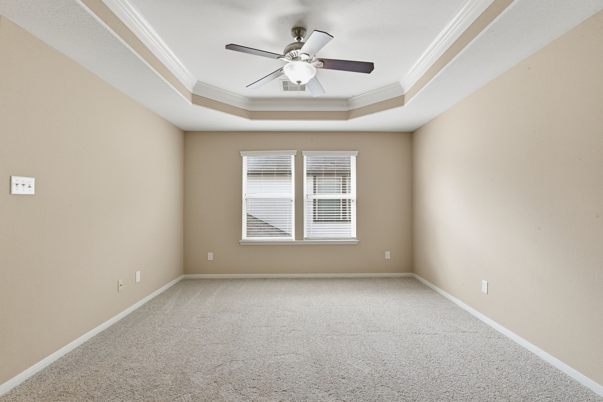 29019 Comal Karst Drive Spring, TX 77386 - Photo 33 of 50 an empty room with a chandelier fan and windows
