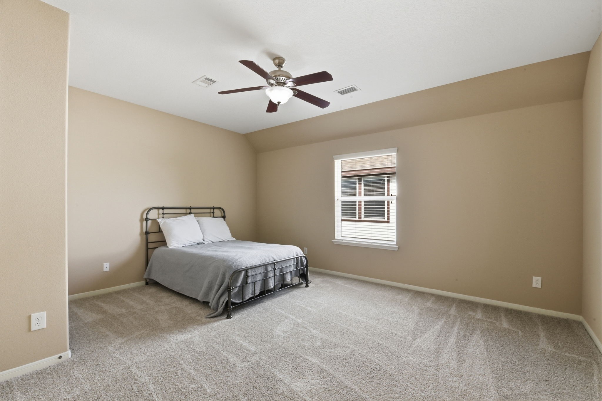 29019 Comal Karst Drive Spring, TX 77386 - Photo 38 of 50 a spacious bedroom with a bed and window