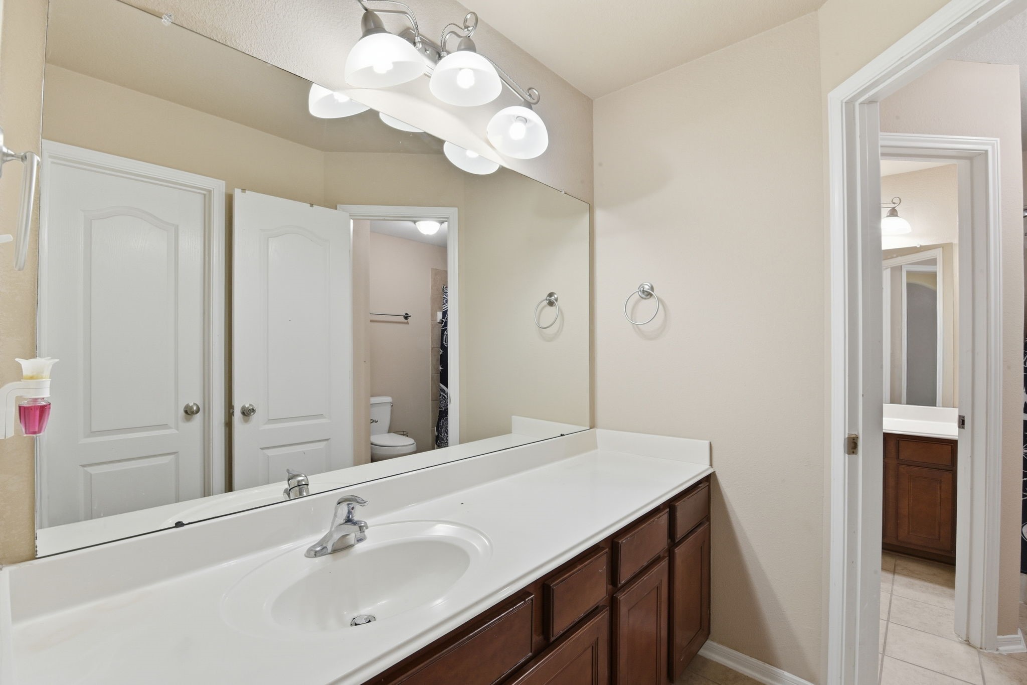 29019 Comal Karst Drive Spring, TX 77386 - Photo 42 of 50 a bathroom with a sink vanity and a mirror